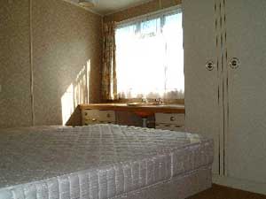 Bedroom 2. Family room with 1 double bed and 1 single bed. Fitted wash hand basin