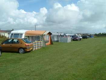 Level pitches and electric hook up available for touring caravans.